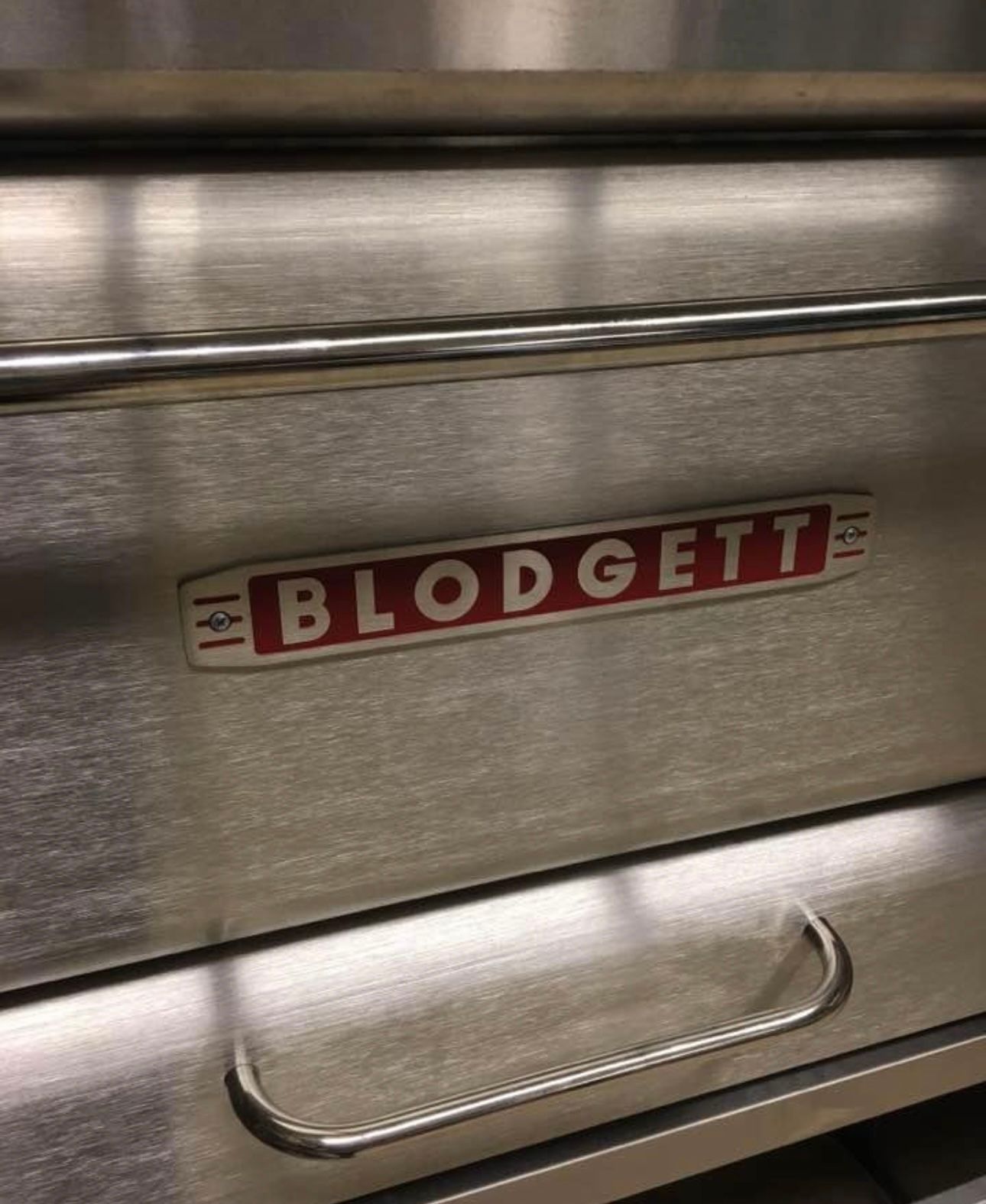 A close up of a stainless steel cabinet with the word budgett on it