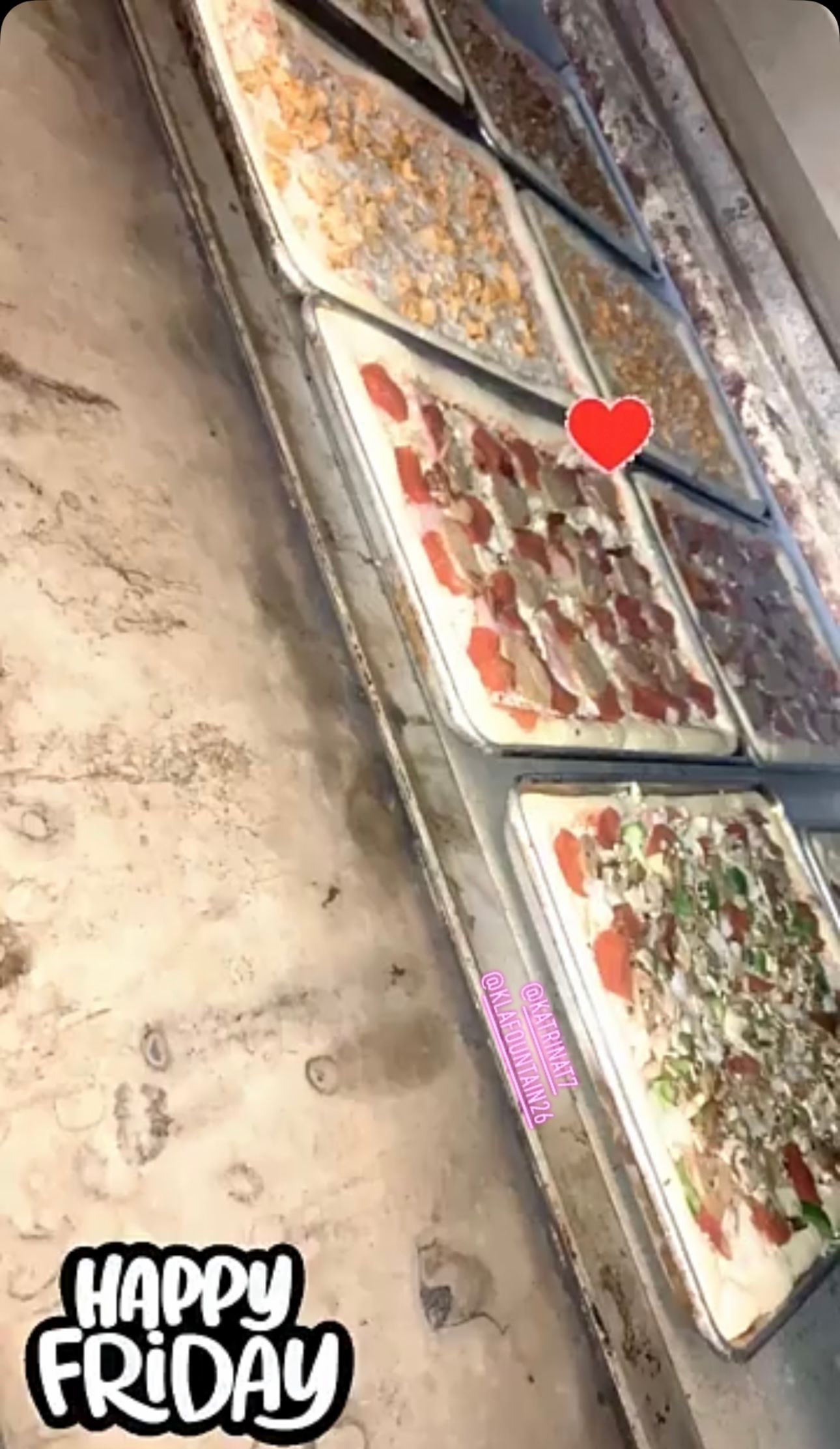 There are many different types of pizzas on the trays.