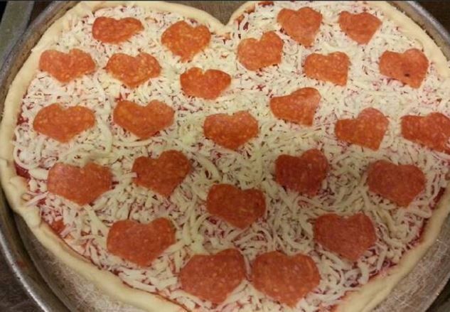 A heart shaped pizza with pepperoni hearts on top