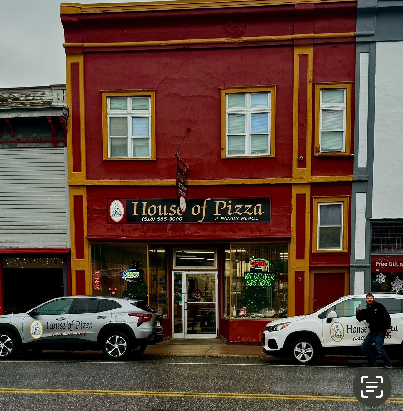 A red building with a sign that says house of pizza