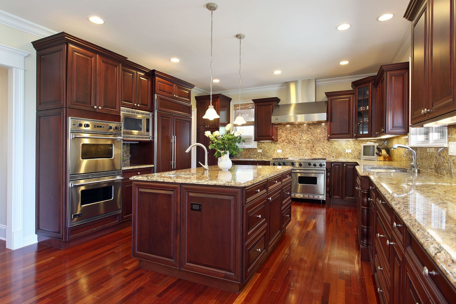 A kitchen with stainless steel appliances and wooden cabinets