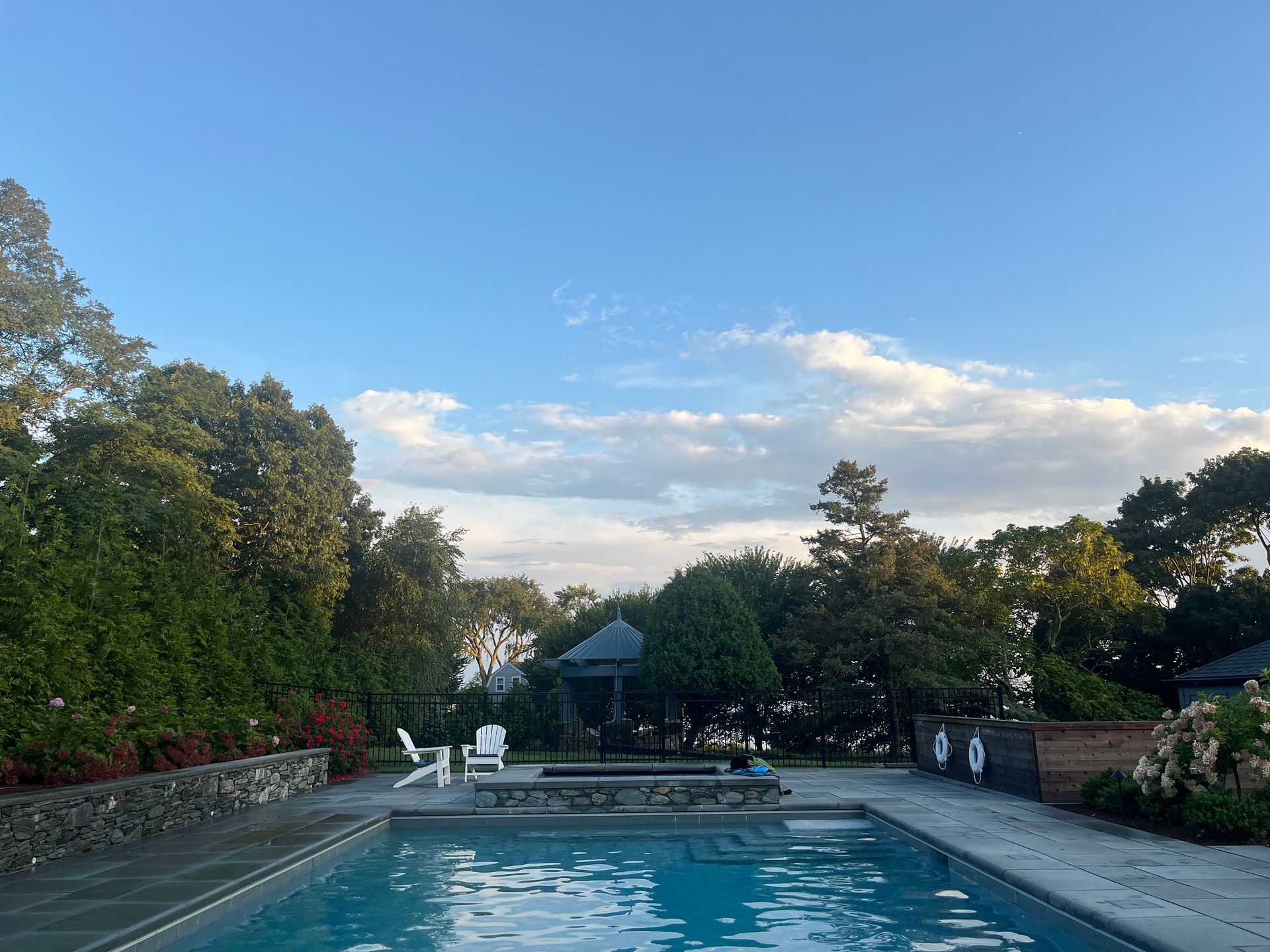 A yellow excavator and a yellow bulldozer are digging in the dirt near a body of water.