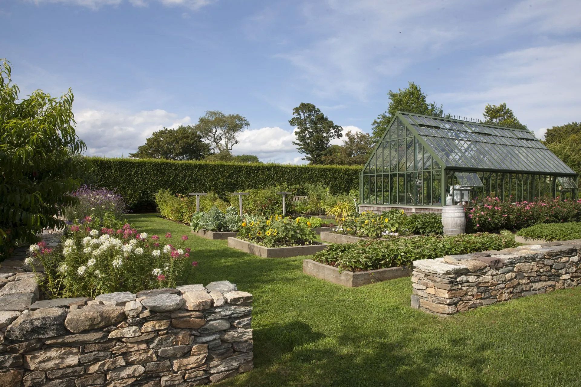 A greenhouse is in the middle of a garden