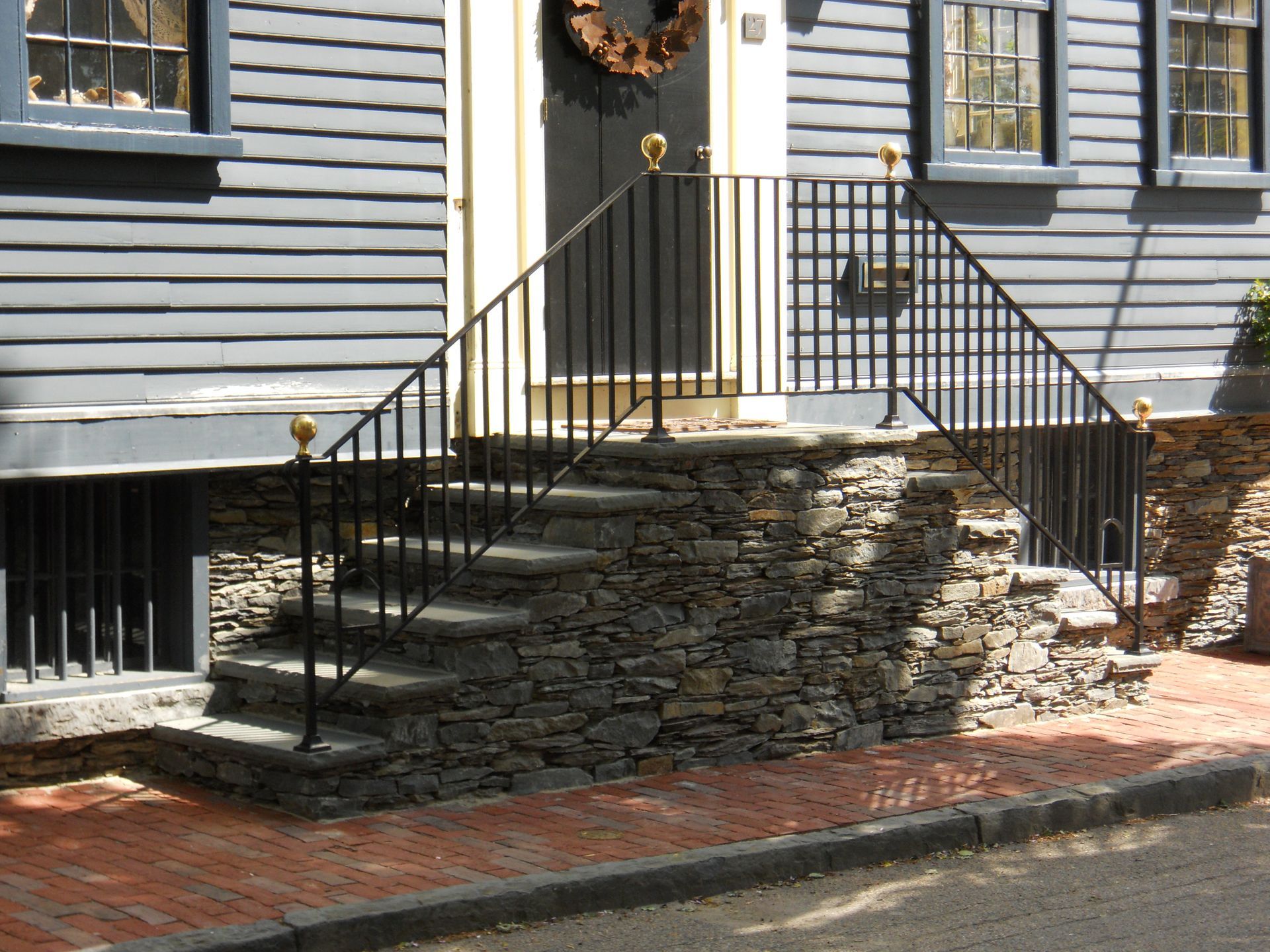 A garden with a white umbrella and chairs in it