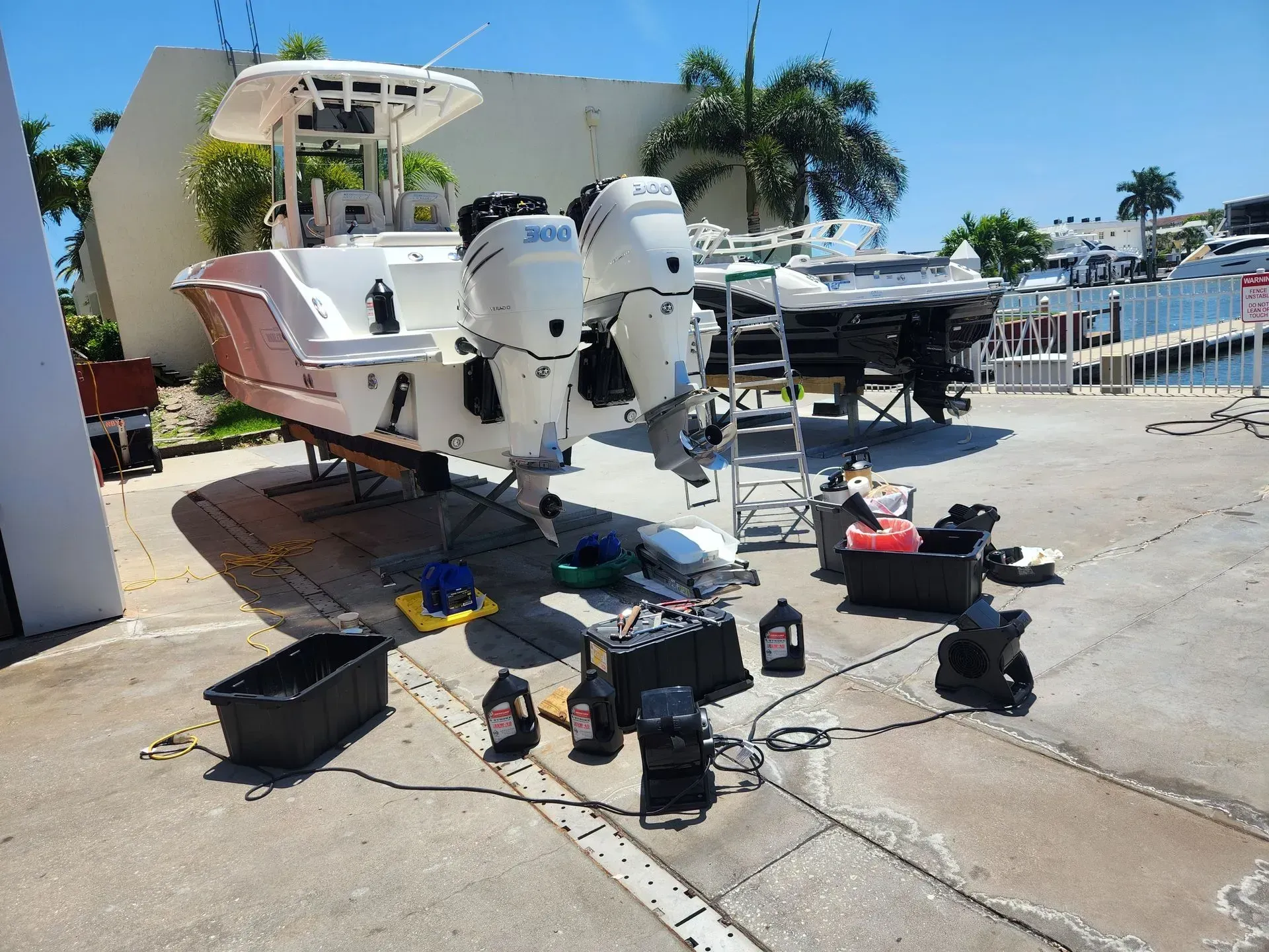 A boat is being worked on in a marina