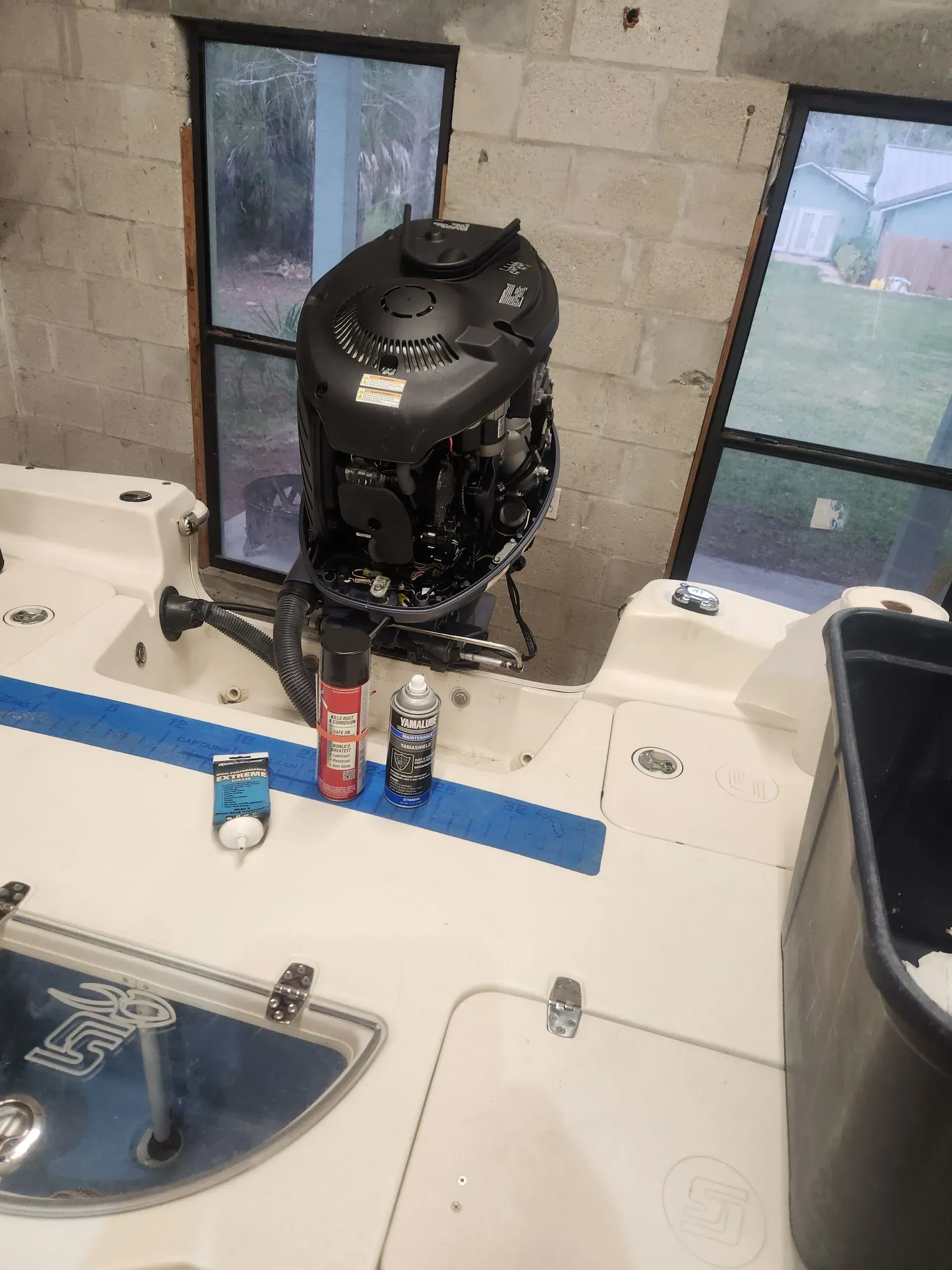 An outboard motor is sitting on the deck of a boat.