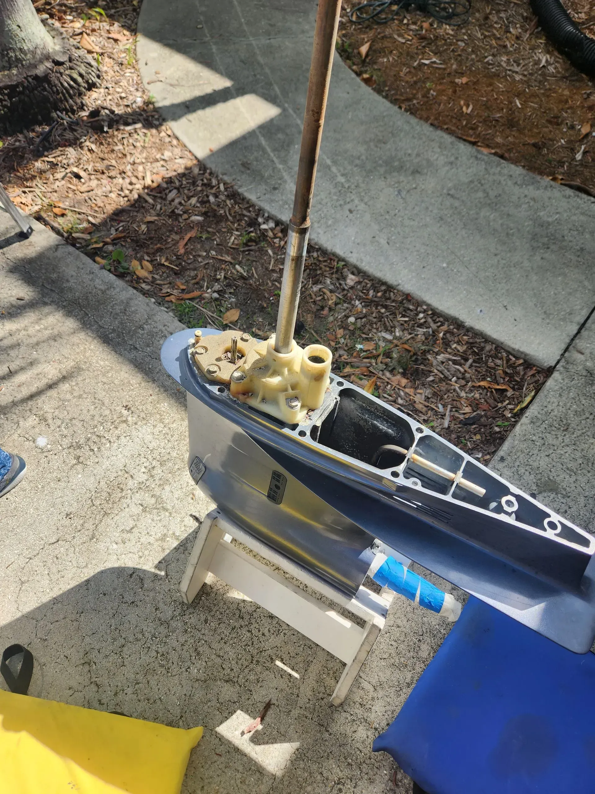 A boat is sitting on a stool on the sidewalk.