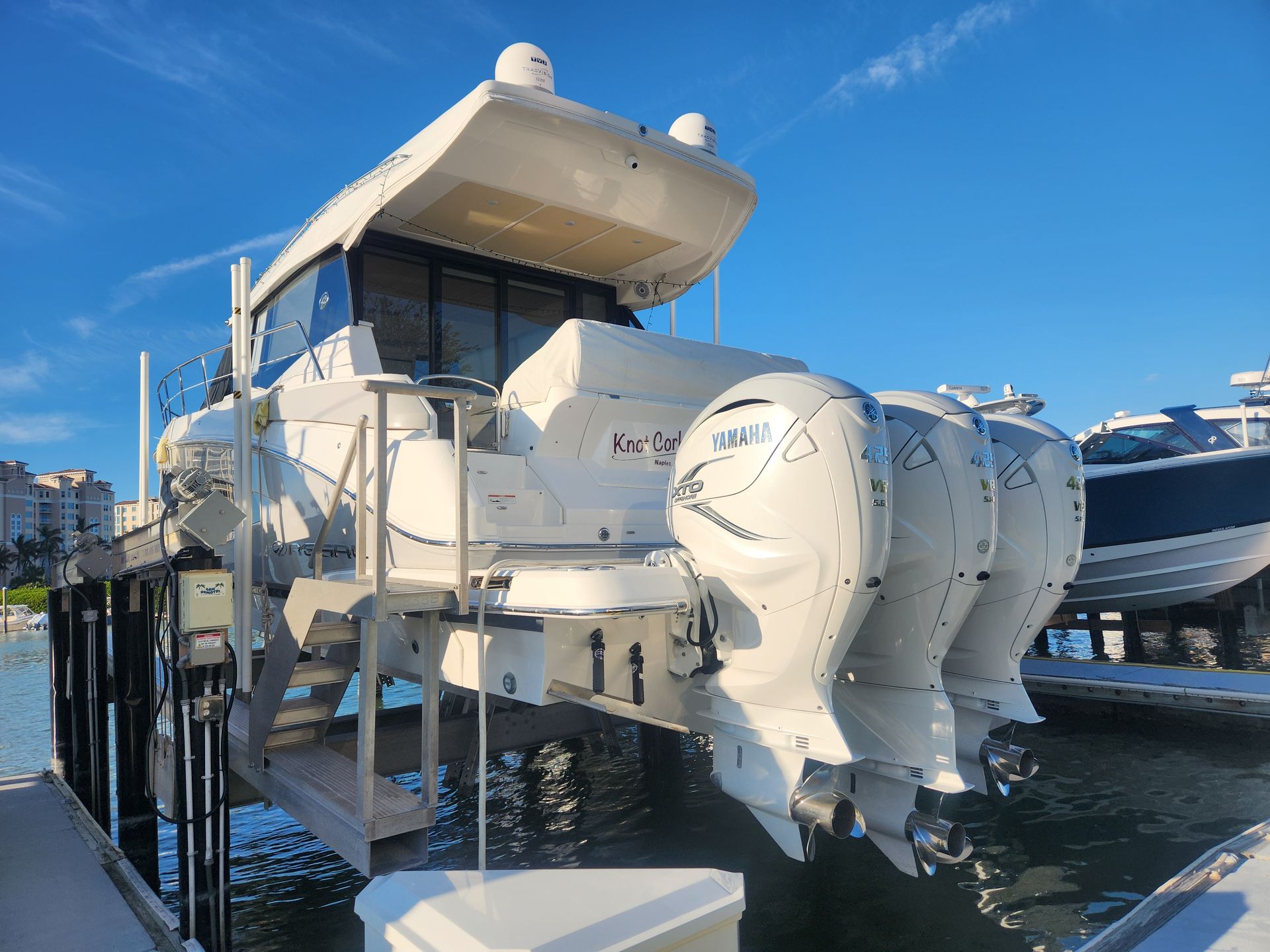 A boat is sitting on a lift in the water.