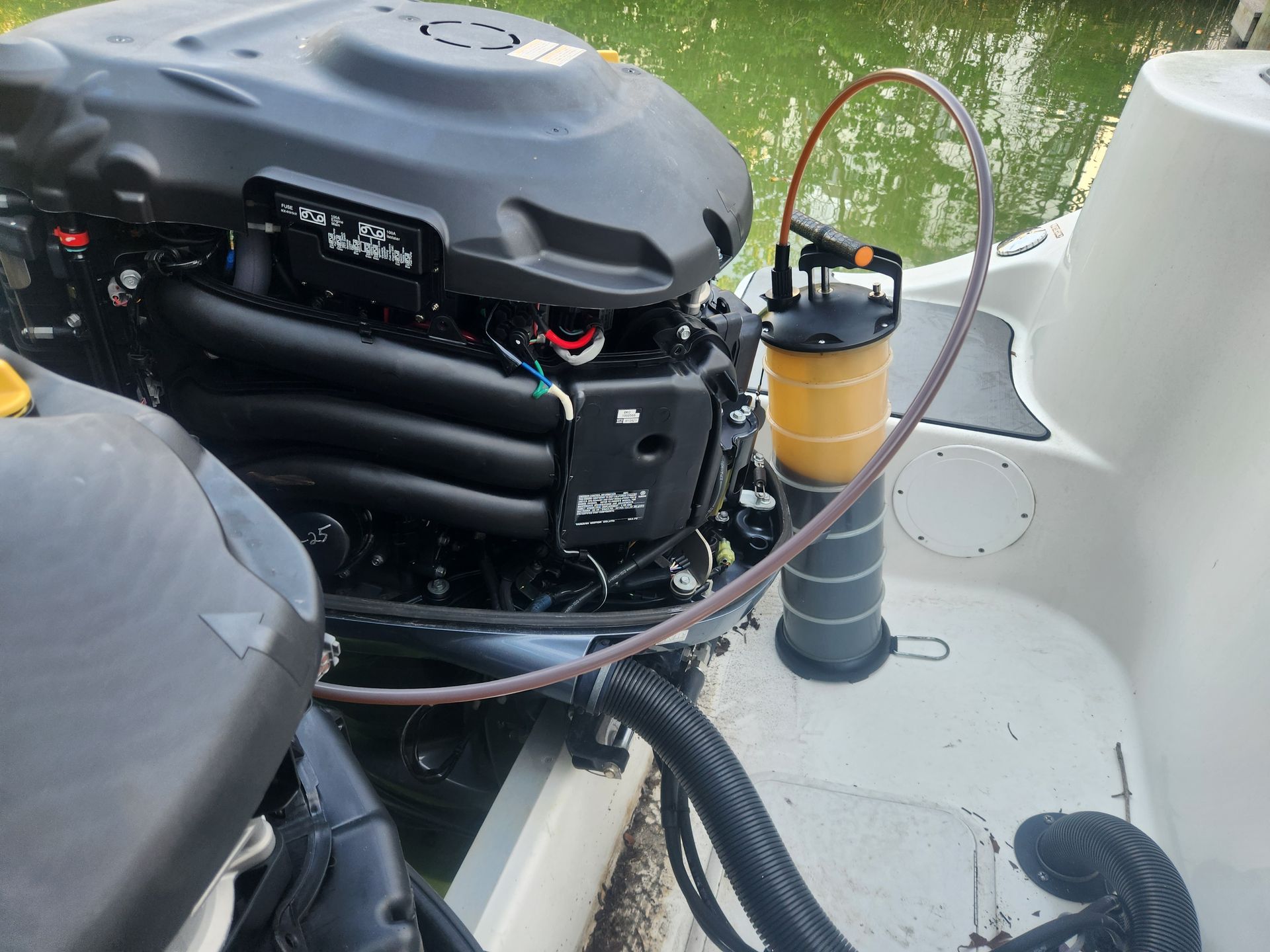 A boat engine with a hose attached to it.