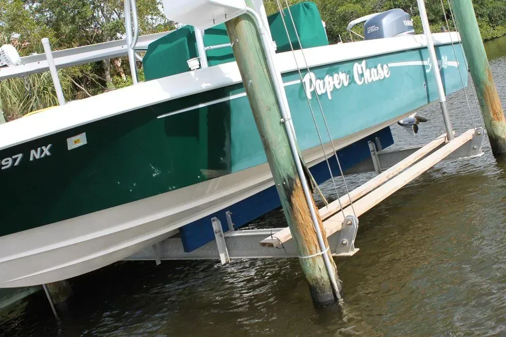 A green boat with the name paper chain on it.