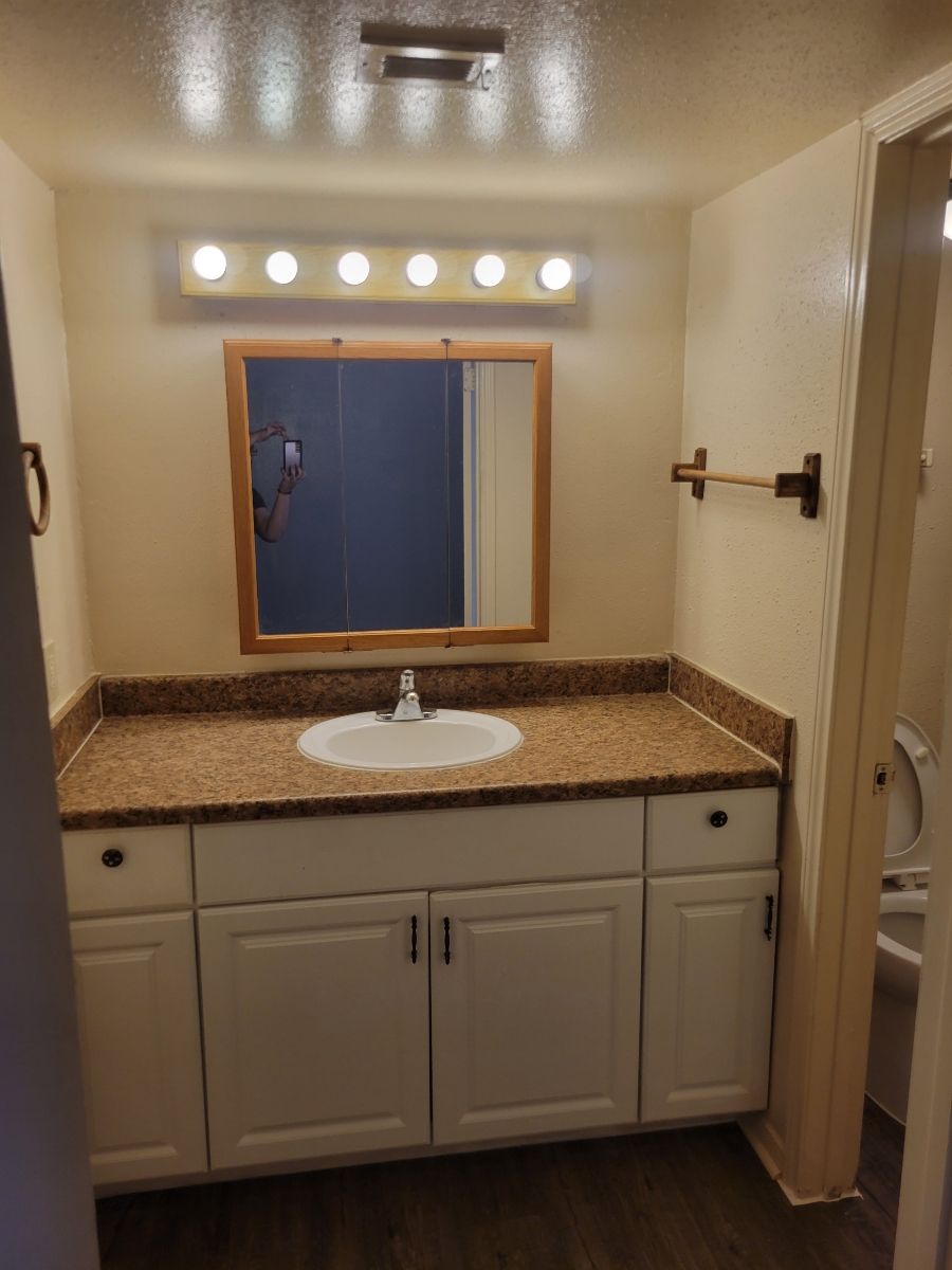 A bathroom with a sink and mirror