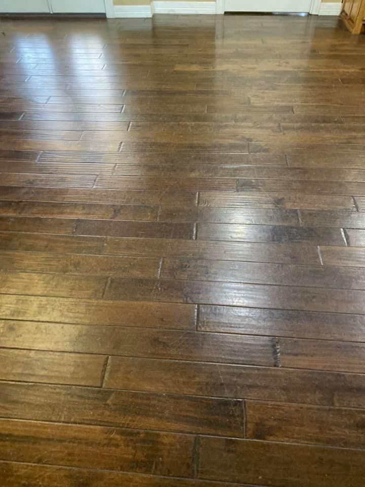 A close up of a wooden floor in a room.