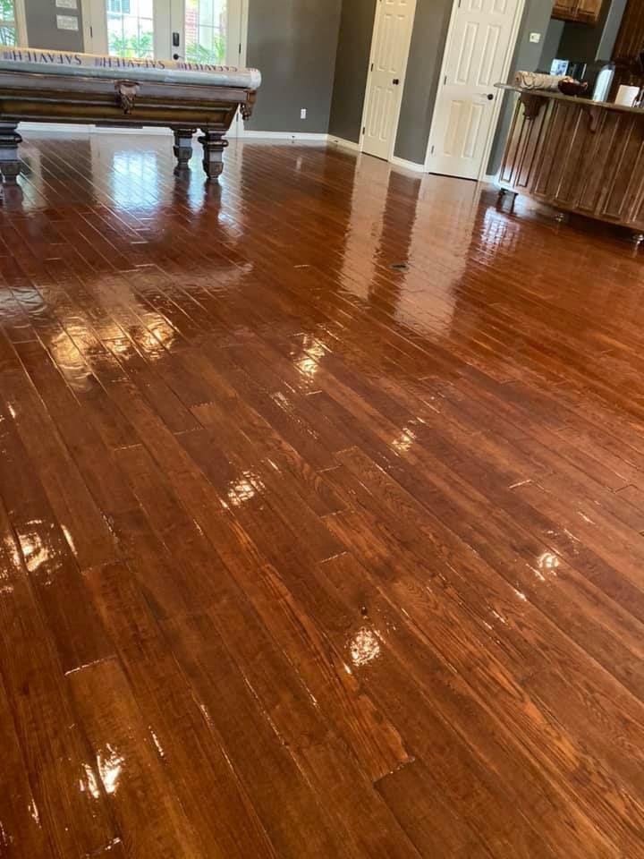 A pool table is sitting on a wooden floor in a living room.