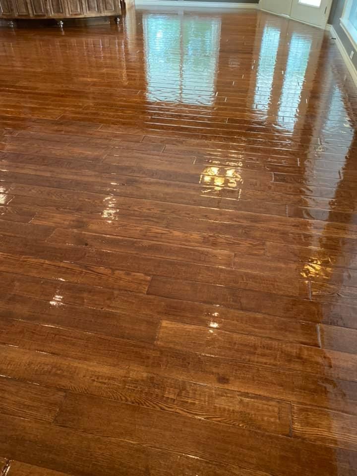 A living room with a shiny wooden floor and a couch.