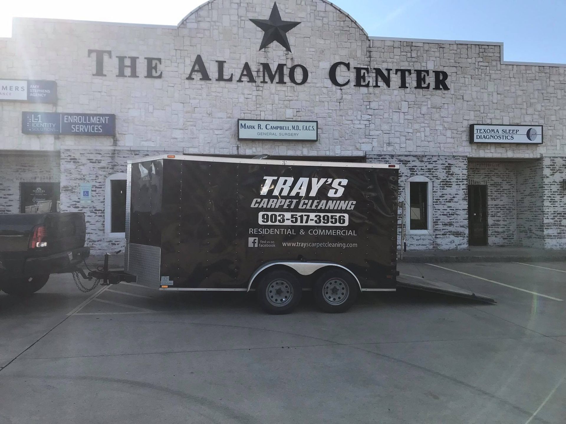 A trailer is parked in front of the alamo center