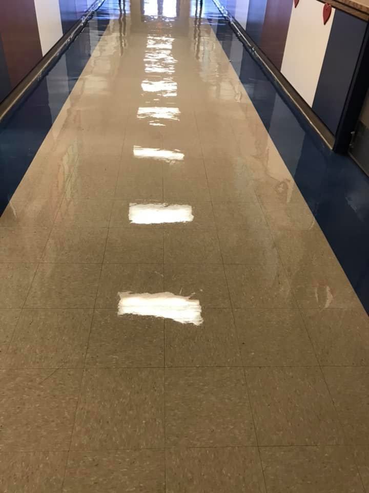 A long hallway with a row of lights on the floor.