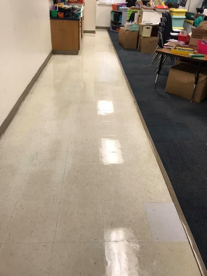 A hallway in a classroom with boxes on the floor.