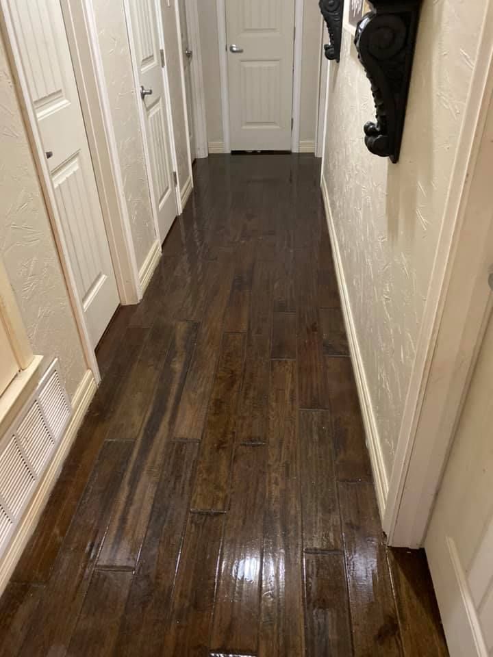 A hallway with hardwood floors and white doors in a house.