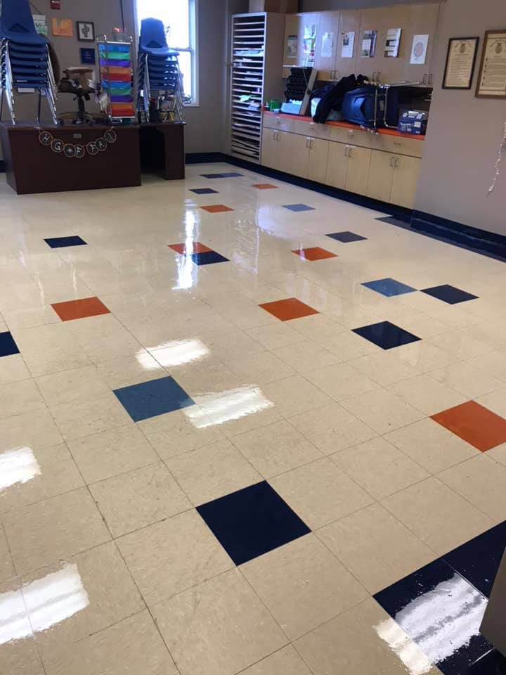 A room with a tiled floor and a desk in the background
