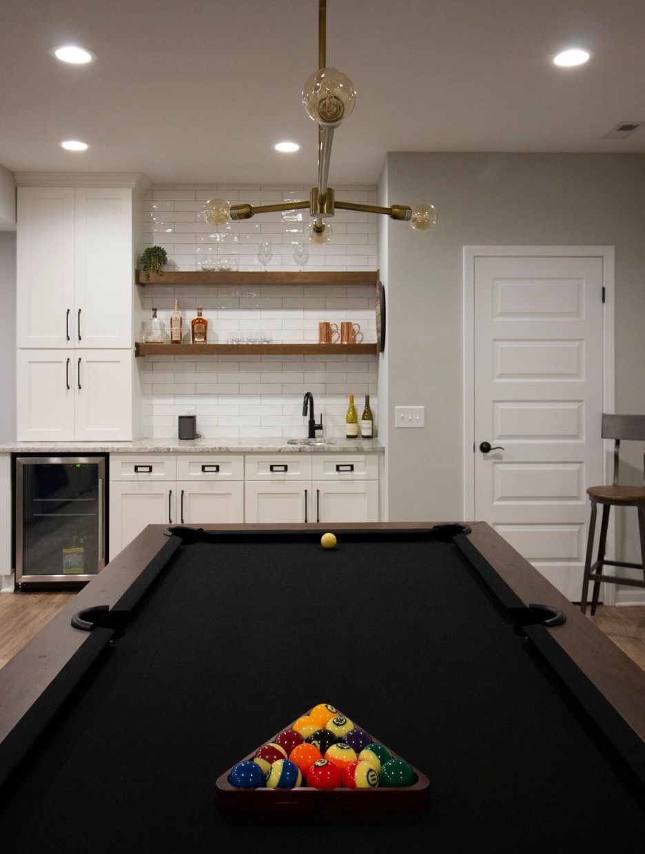 A pool table with a triangle of pool balls on it