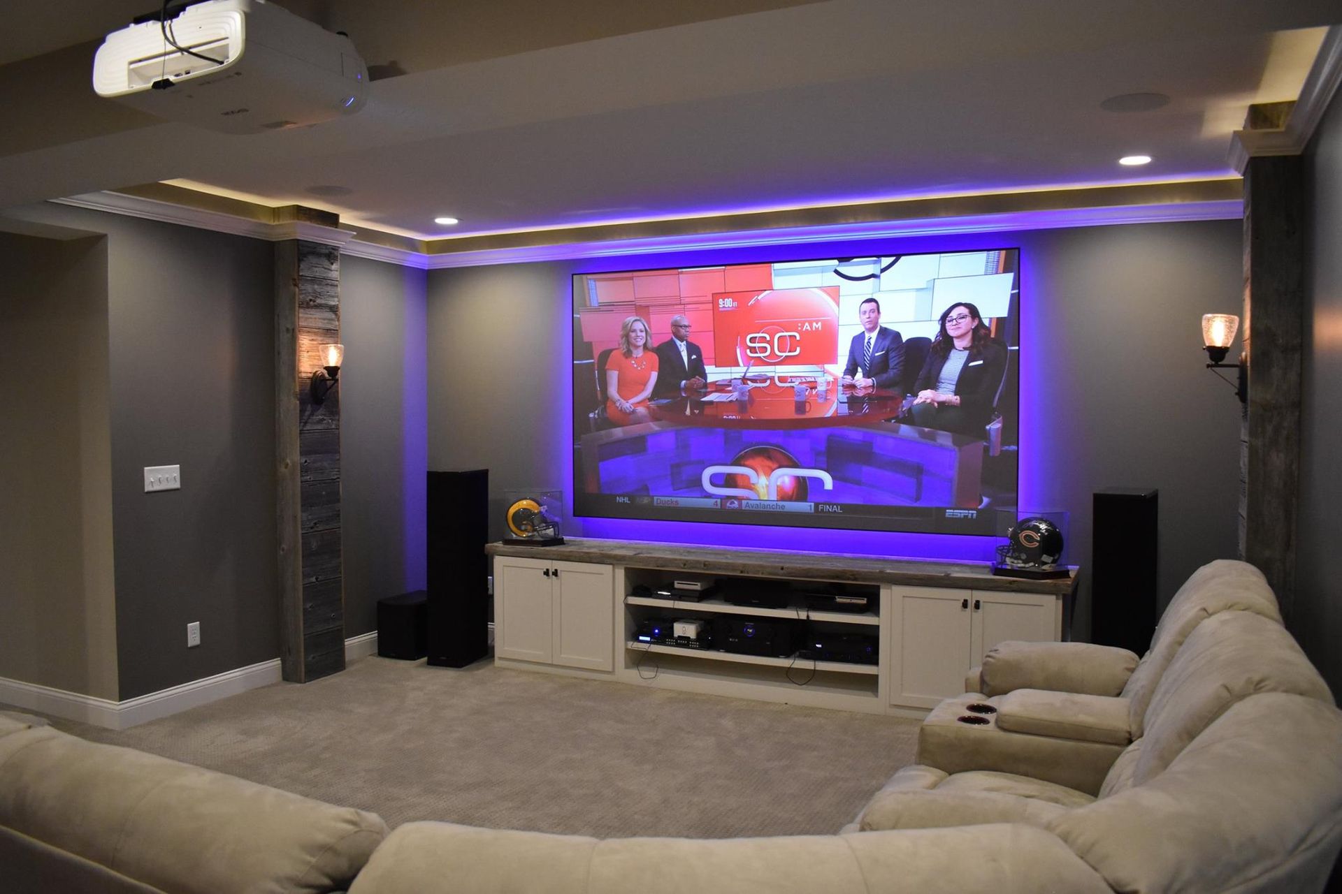 A home theater with a large screen and a projector.