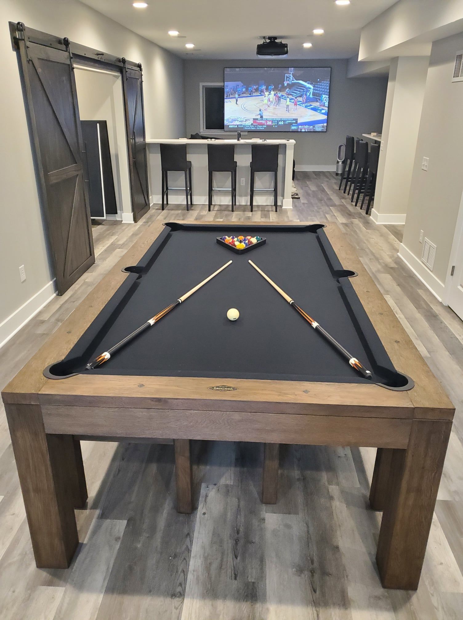 There is a pool table in the middle of the room.