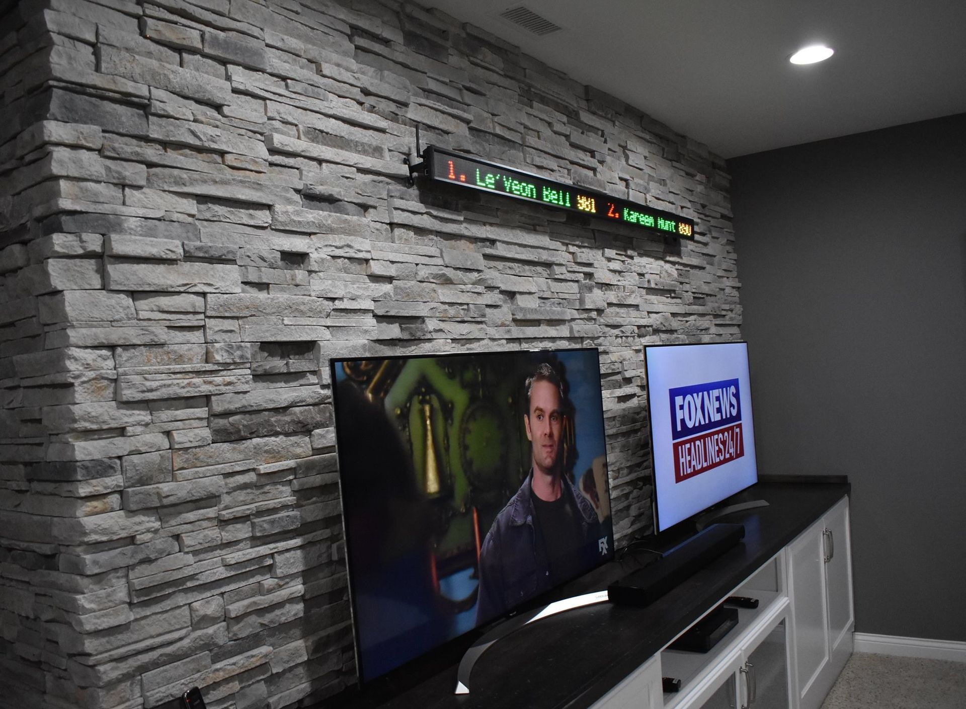 A flat screen tv in a basement living area.