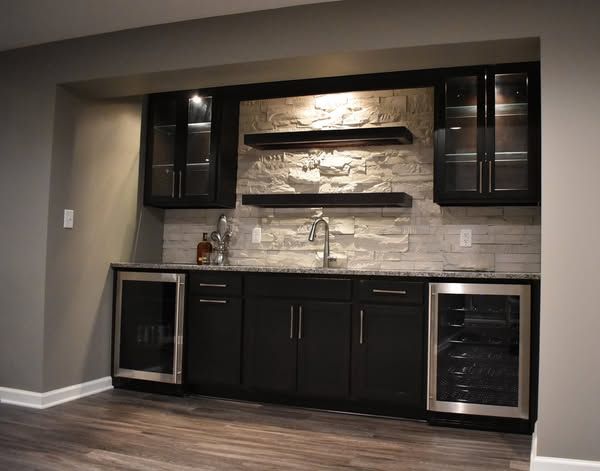A kitchen with black cabinets
