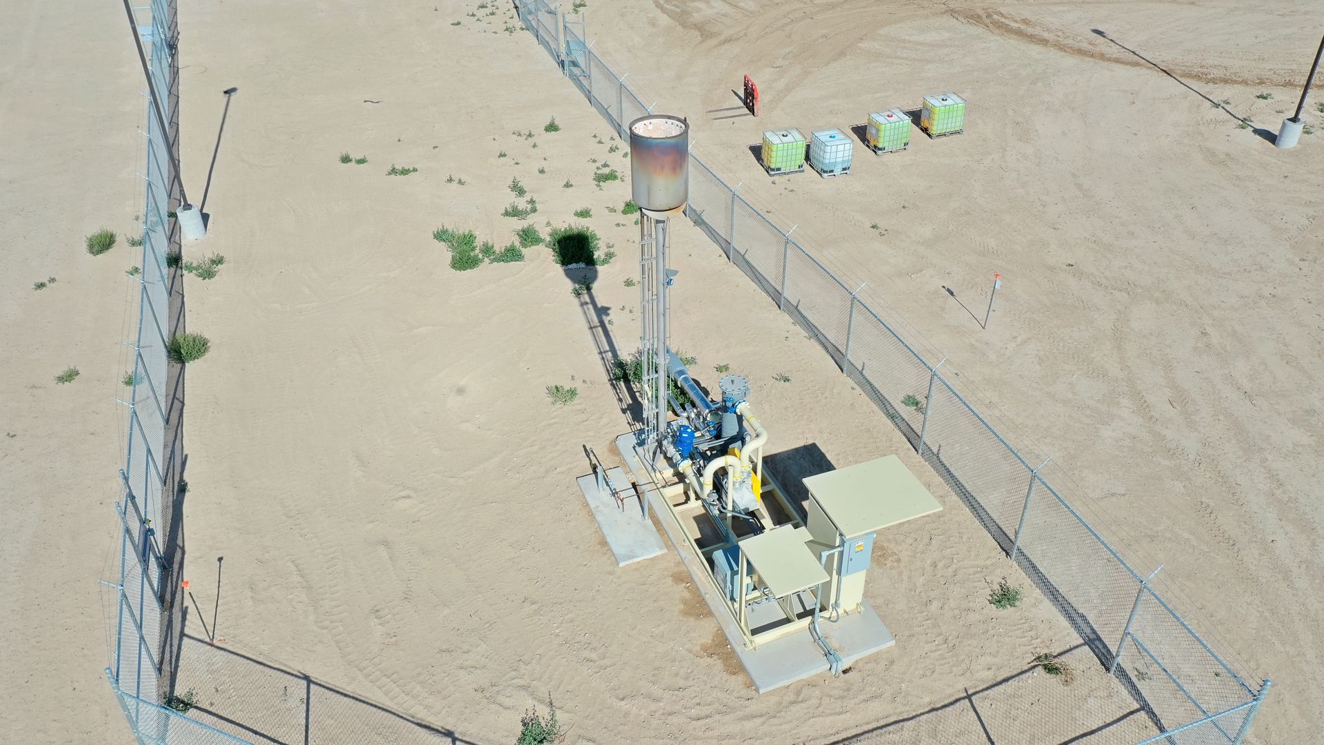 An aerial view of a fenced in area in the desert