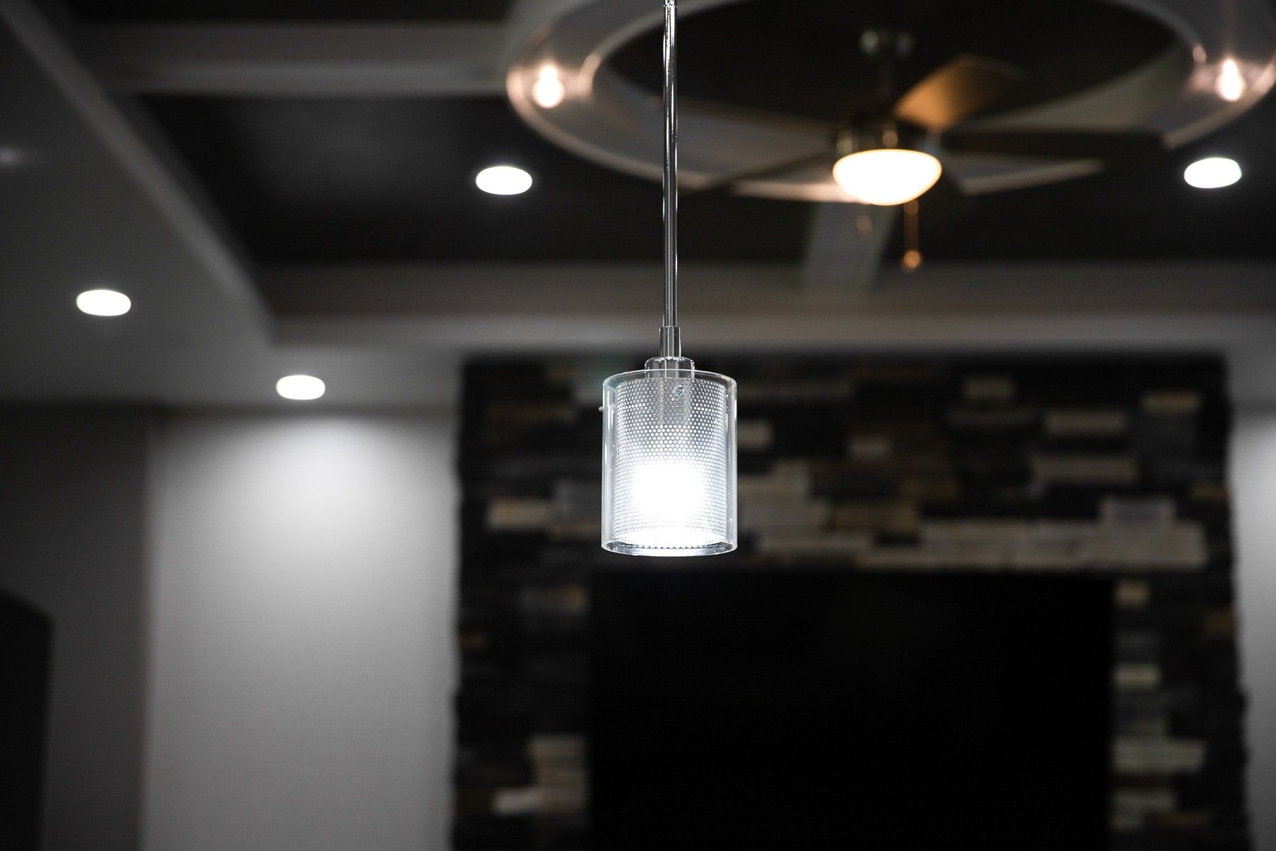 A pendant light is hanging from the ceiling in a living room.