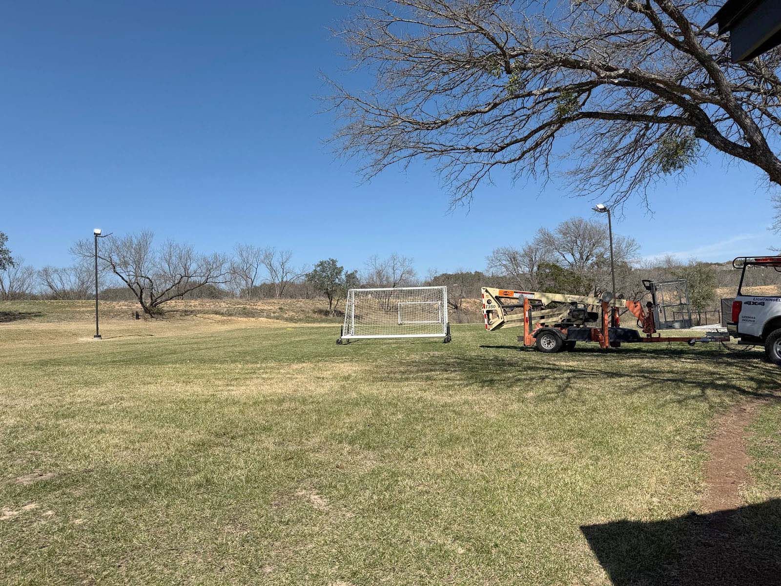 Newly installed light poles on a soccer field