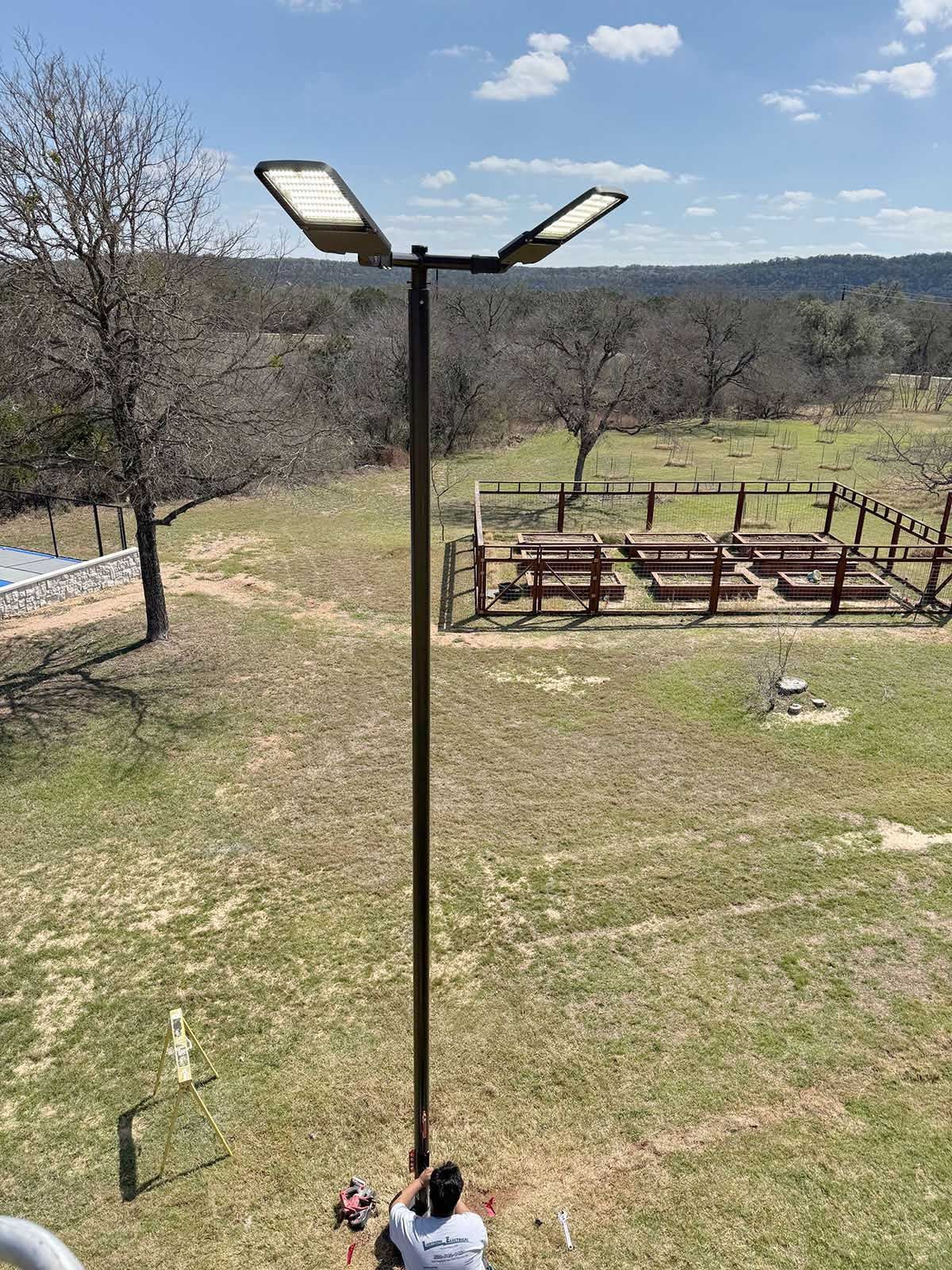 A man installing a light pole 