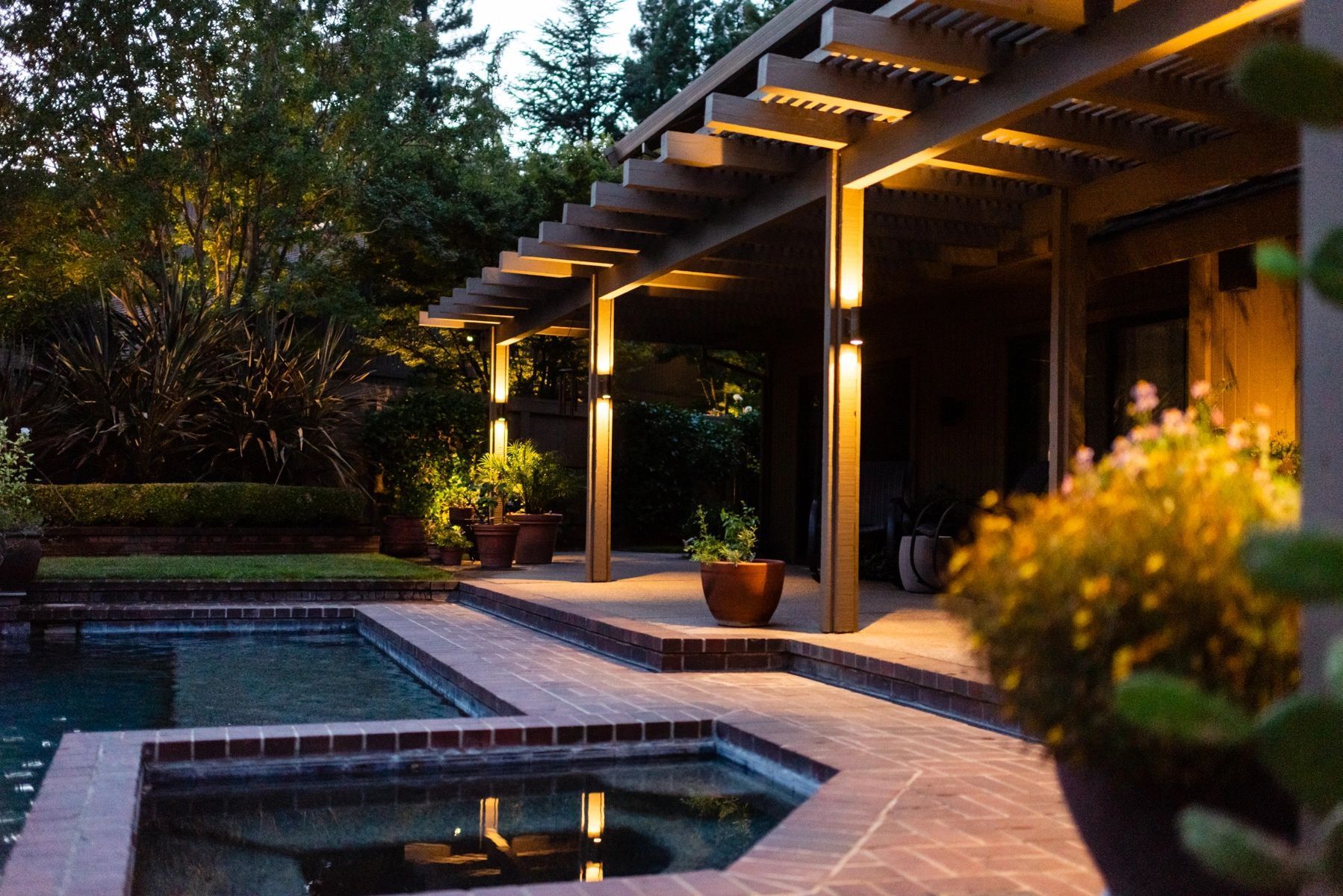 A patio with a pergola and a swimming pool