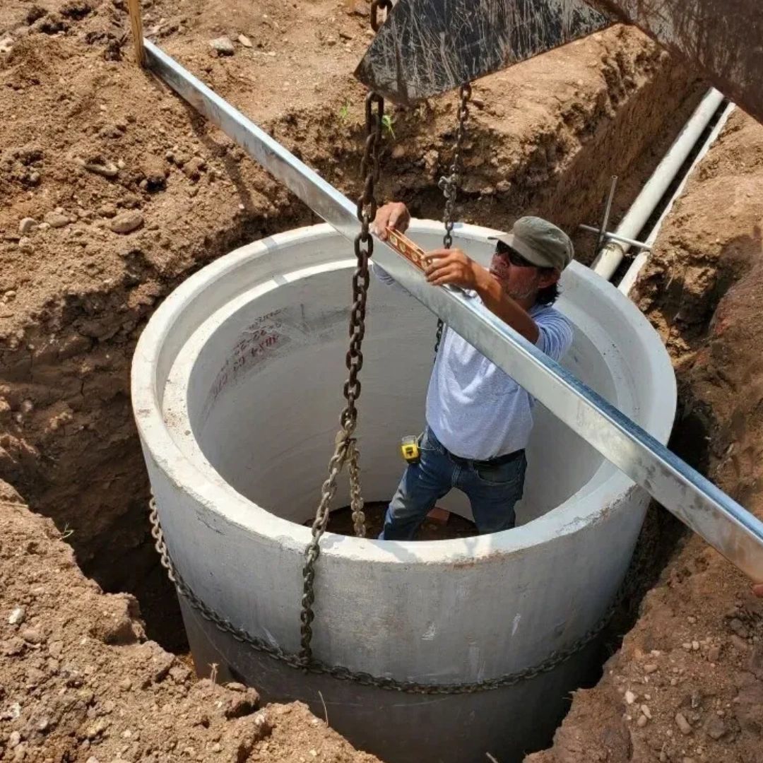 A man is standing inside of a large concrete ring