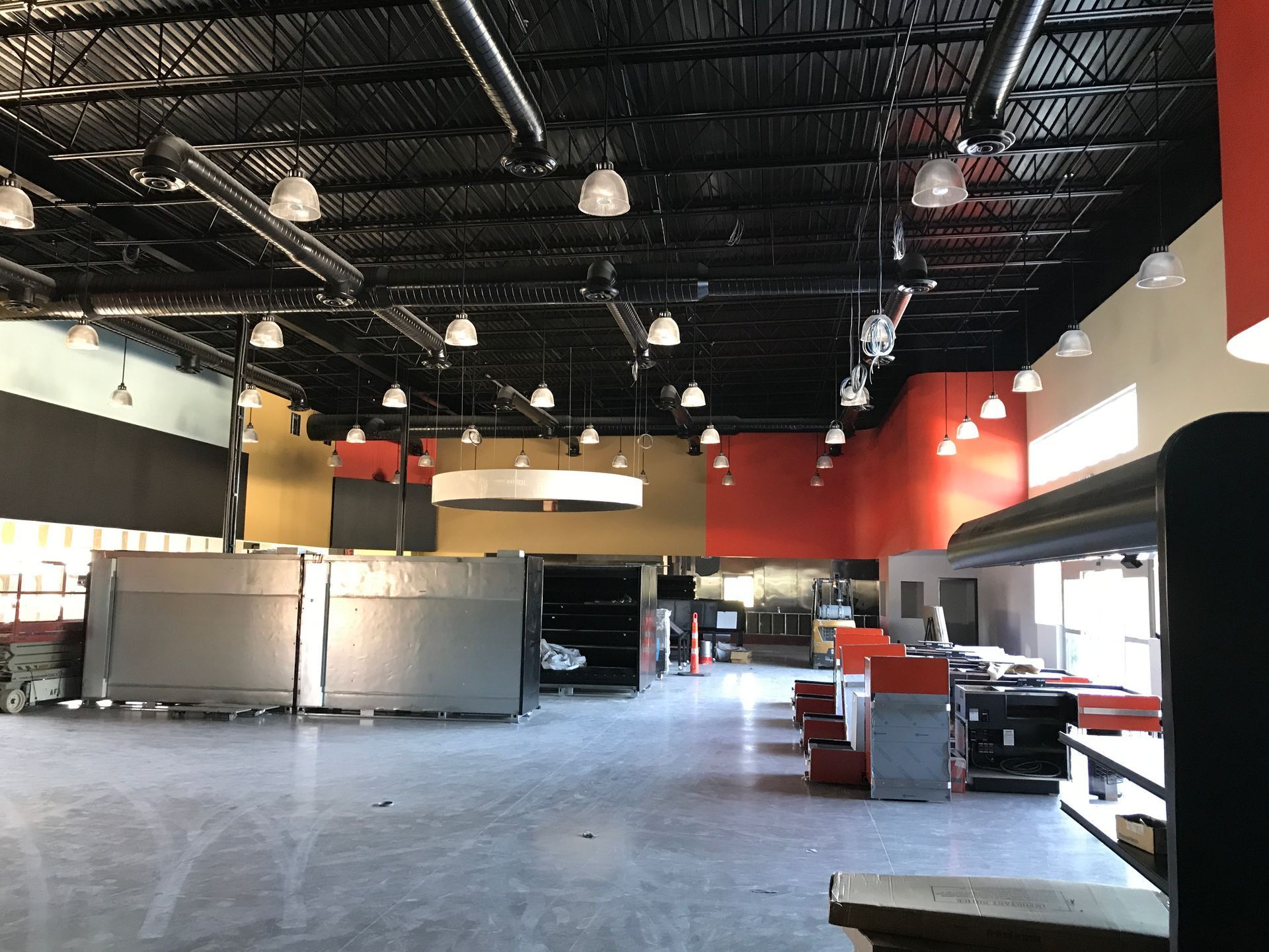 A large empty room with a lot of lights on the ceiling