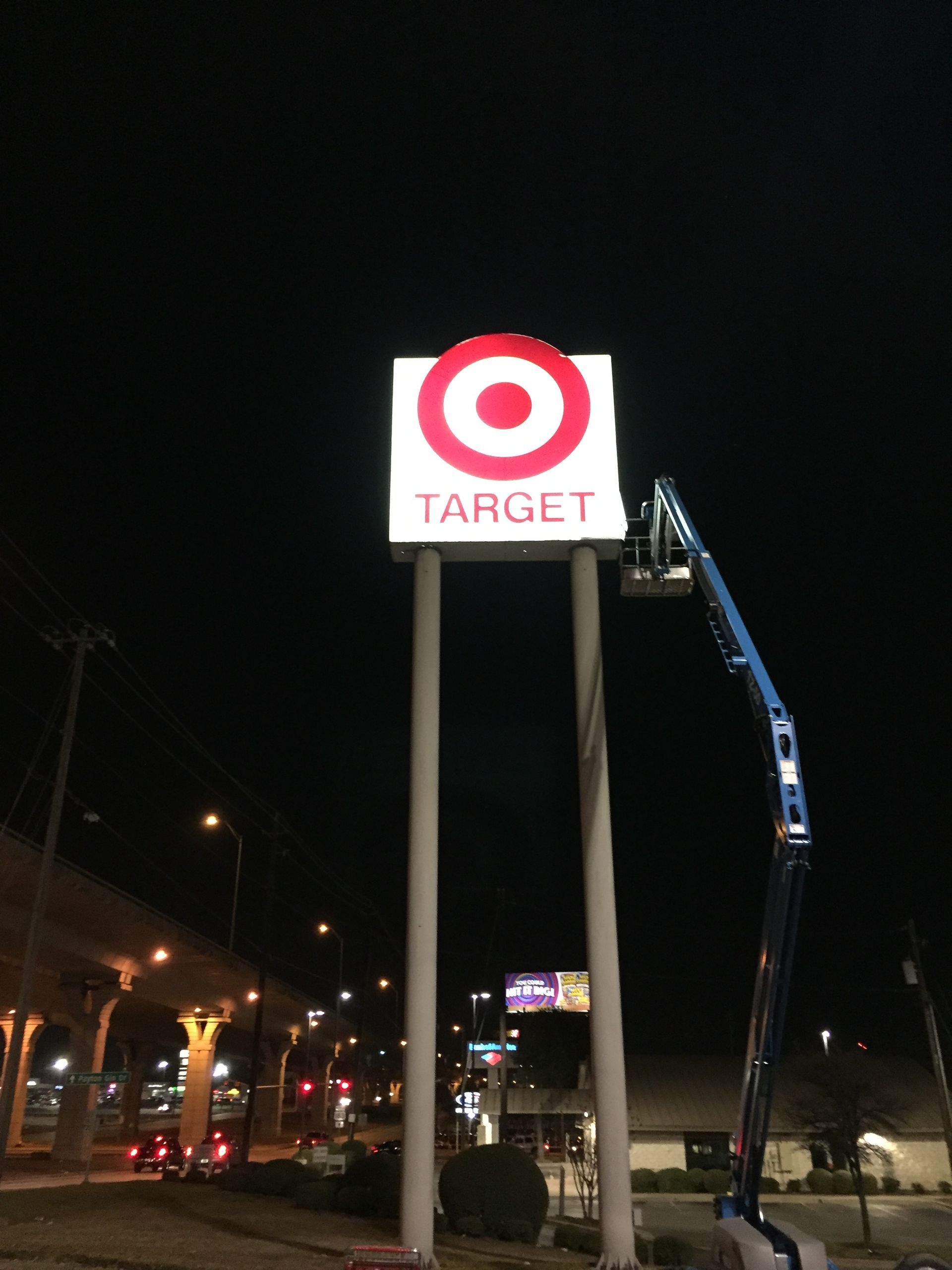 A large target sign is lit up at night.