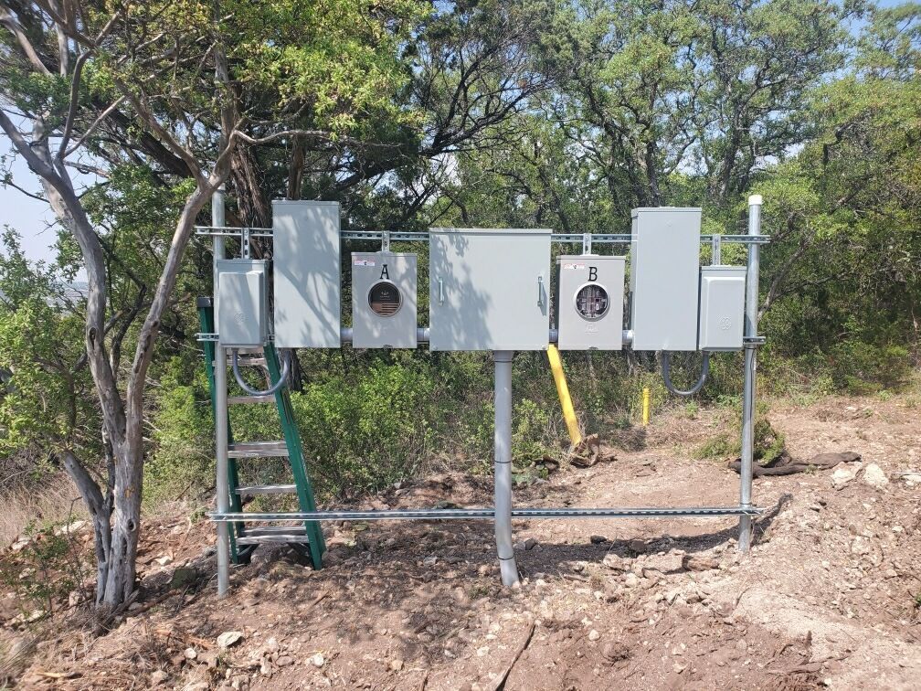 A ladder is attached to a metal structure in the middle of a field.