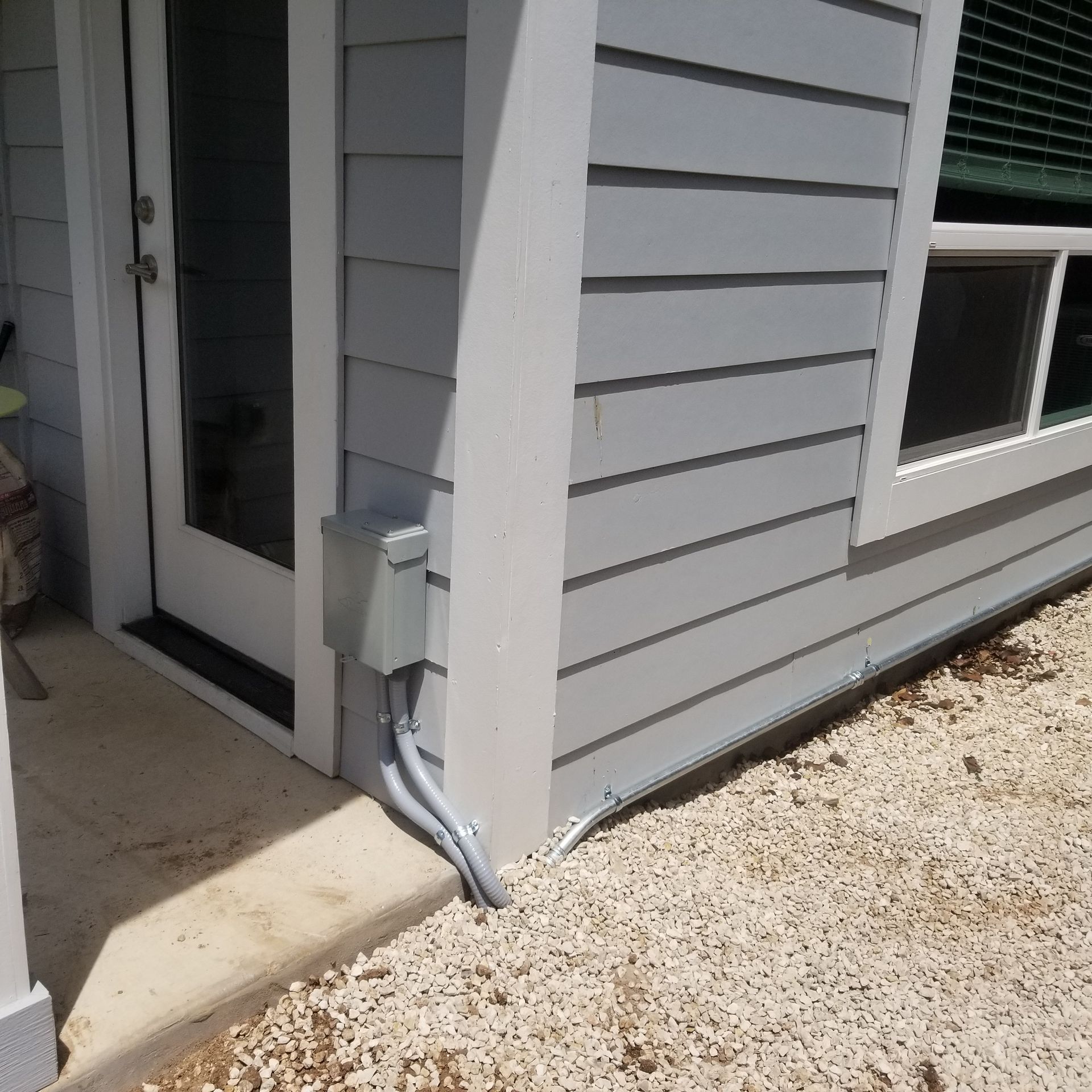 A white house with a sliding glass door and a window