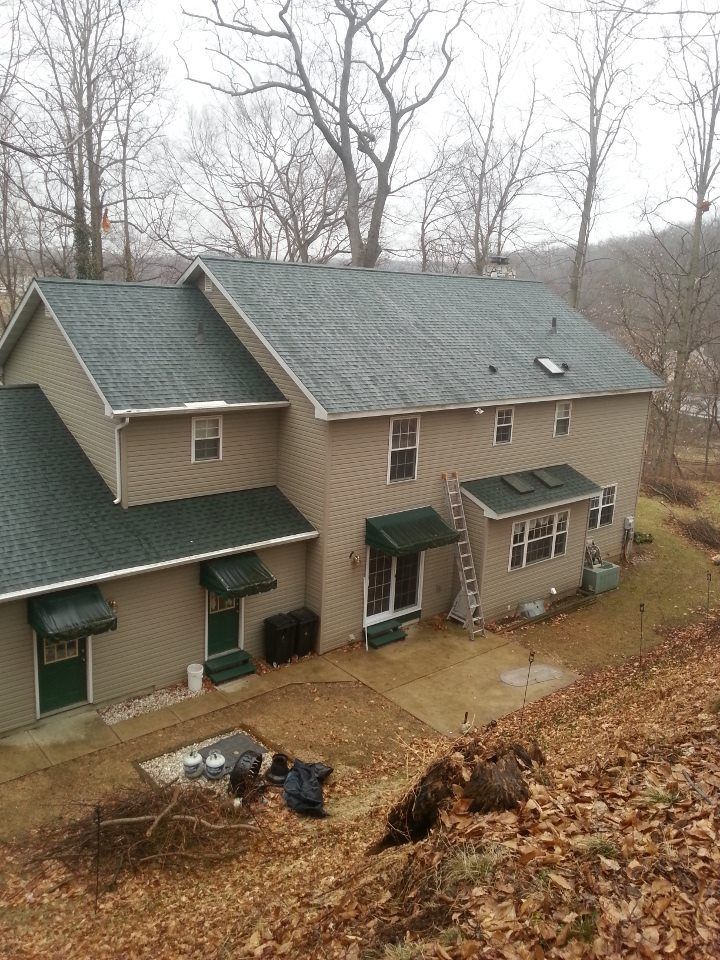 An aerial view of a house with a green roof