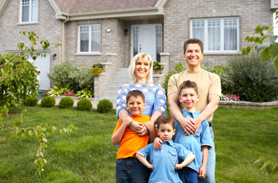 family in front of house