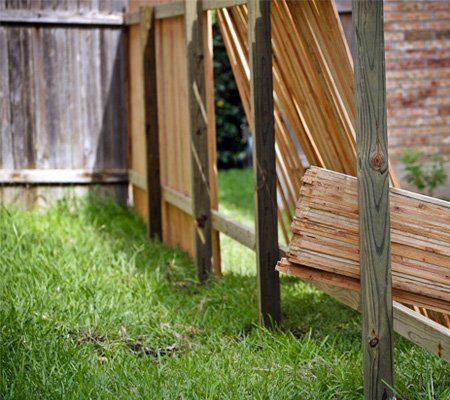 Backyard with lumber for new privacy fence