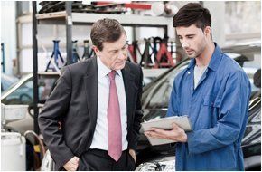 Auto repairman showing his observations about the problem of the customer's car