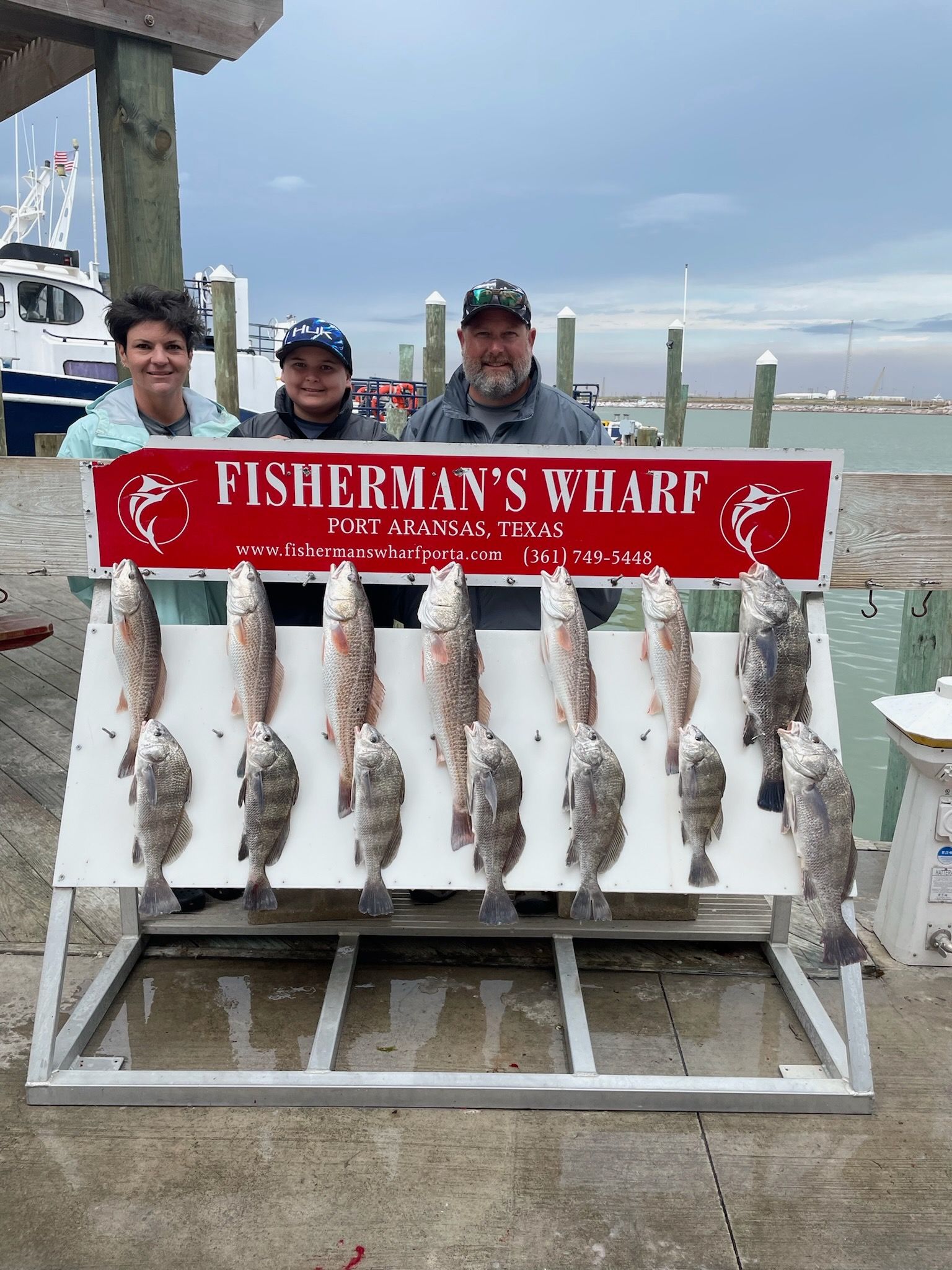 A fisherman 's wharf sign with a bunch of fish on it