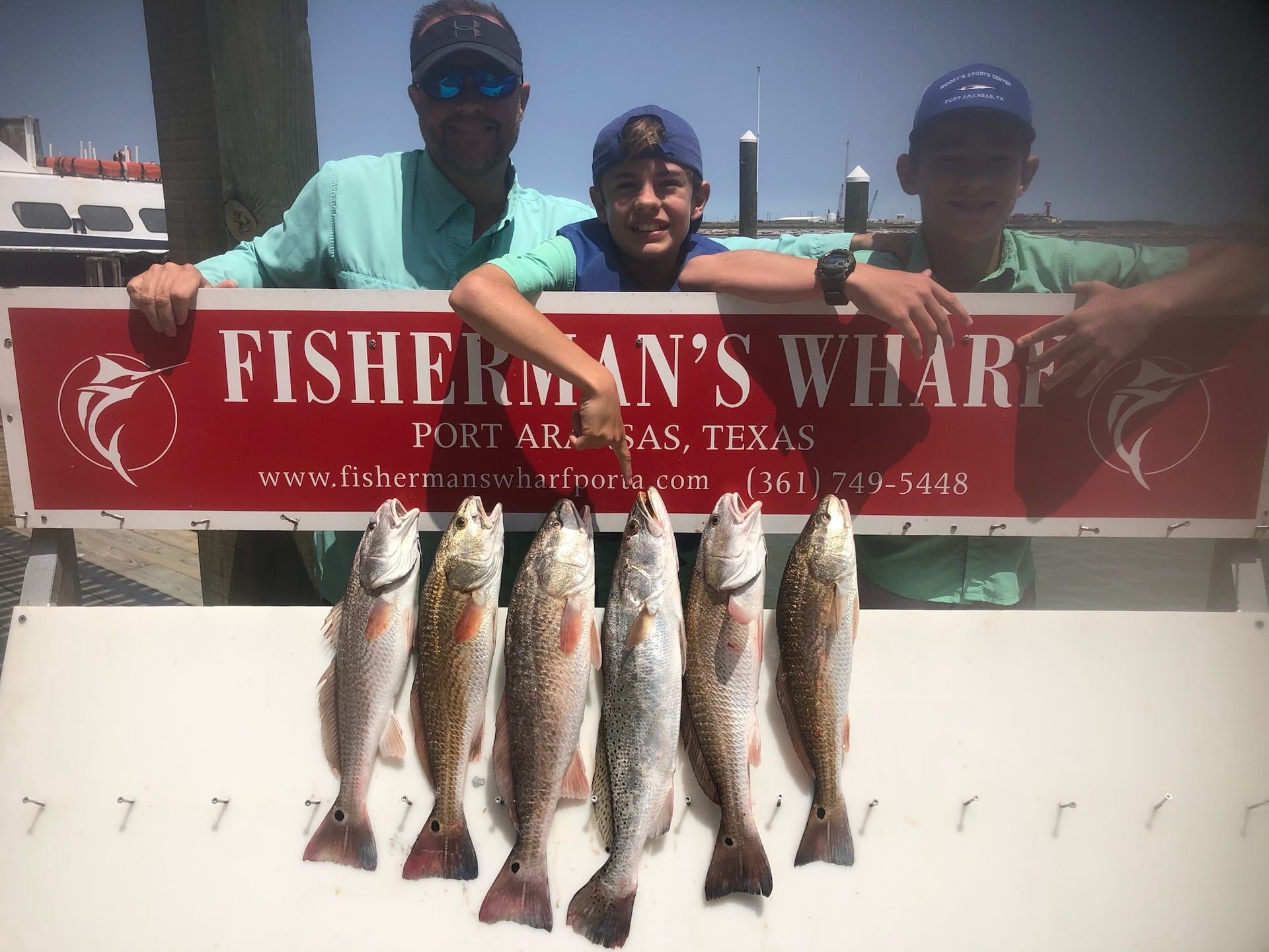 Fisherman 's wharf port arkansas texas is displayed on a sign
