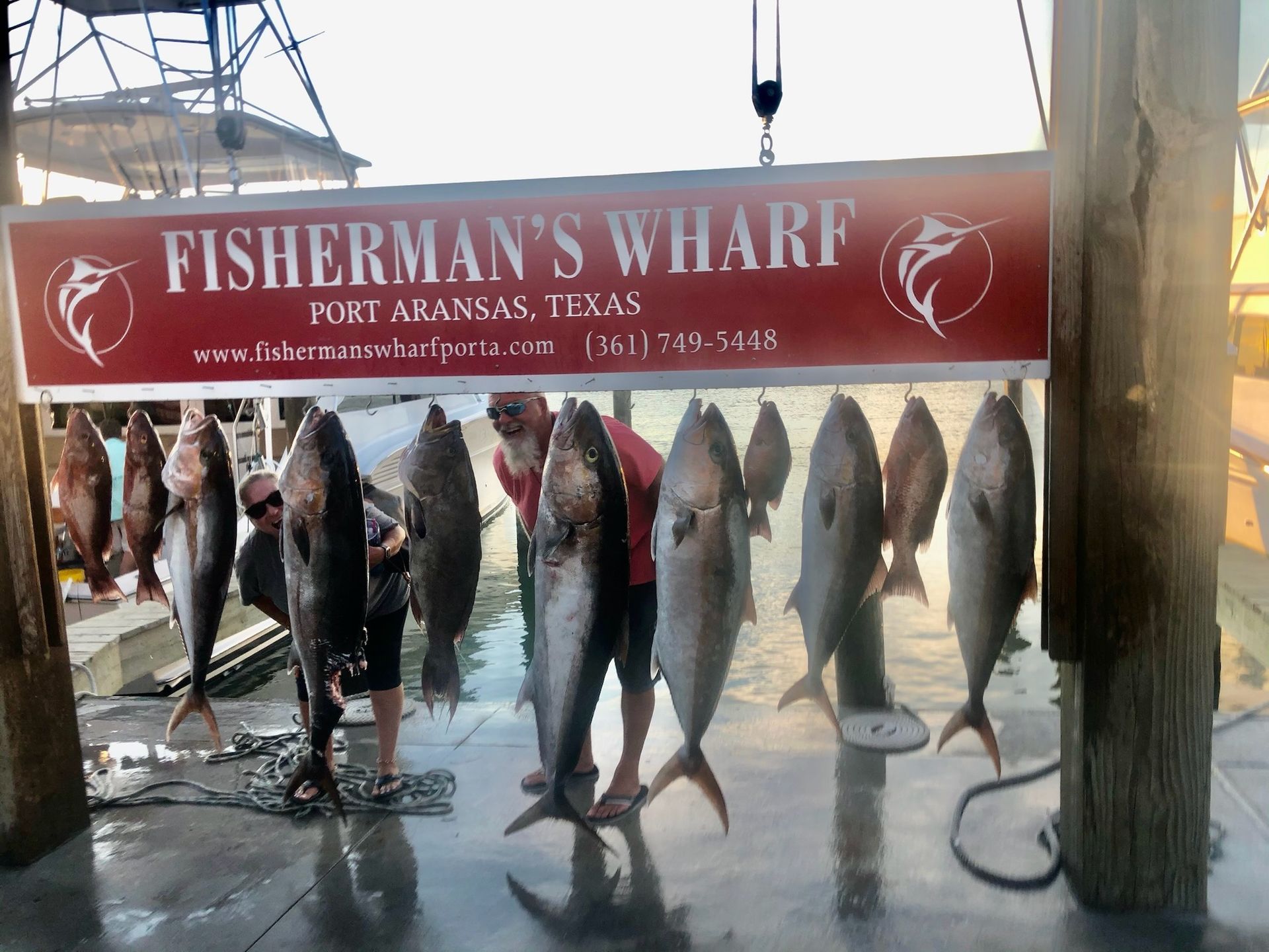 Fisherman 's wharf in port arkansas texas is a fishing dock with lots of fish