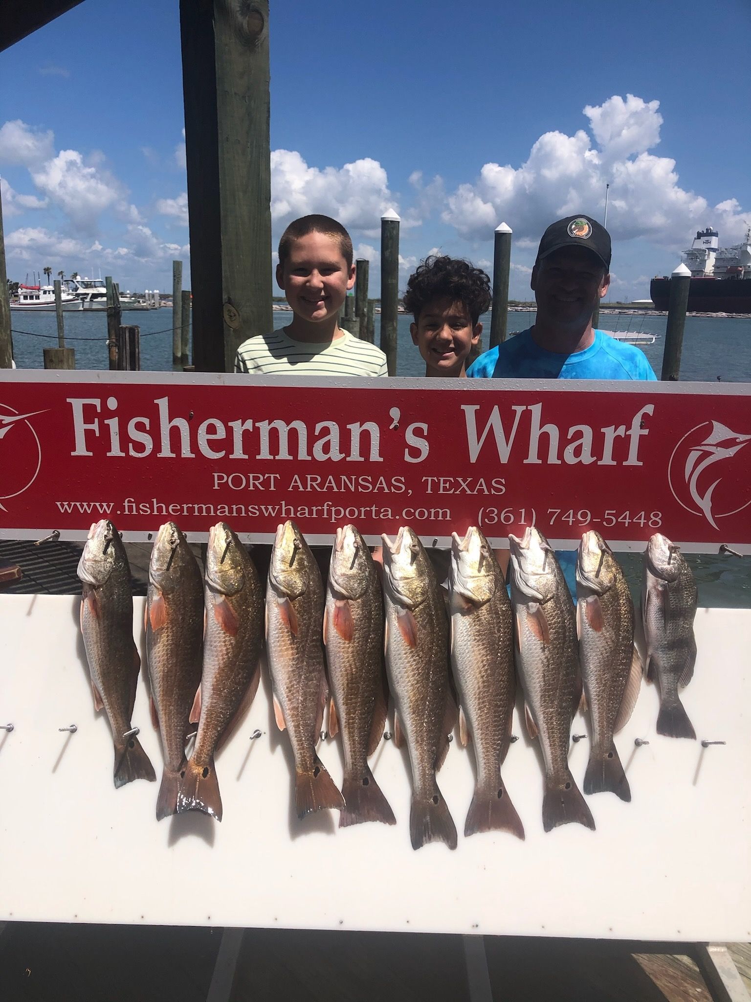 A fisherman 's wharf sign with a bunch of fish on it