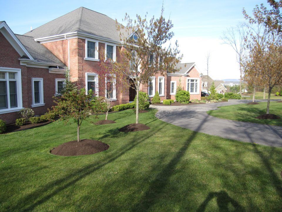 a large brick house with a driveway leading to it