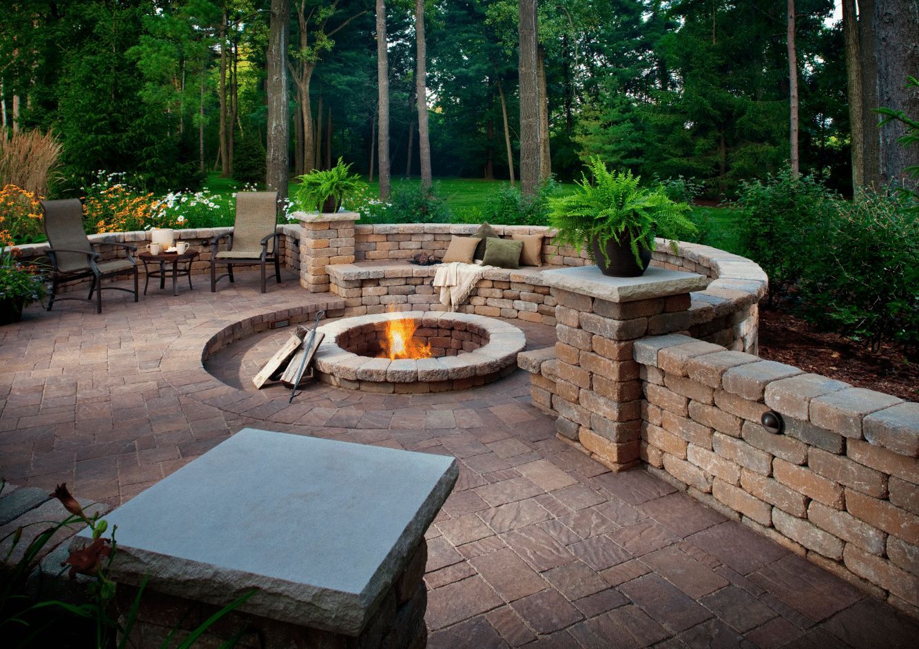 There is a fire pit in the middle of the patio
