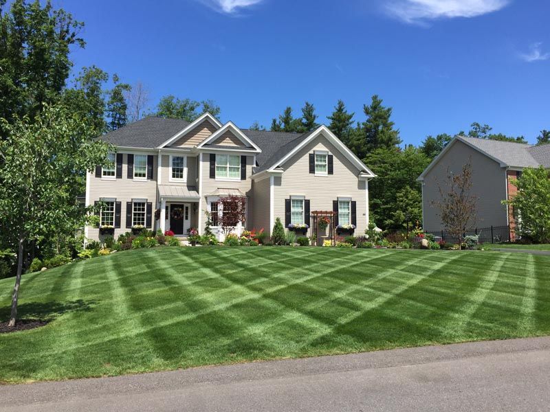 A large house with a lush green lawn in front of it