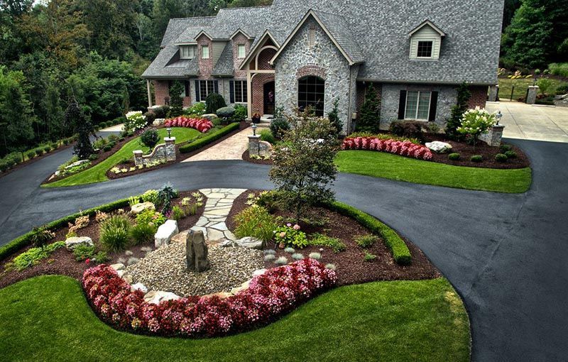 An aerial view of a large house with a large driveway